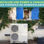 Un chauffagiste pompe a chaleur a installé une pompe a chaleur dehors devant une fenêtre aux volets bleus.